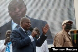 FILE - President Faustin-Archange Touadera greets supporters after highest court confirmed his re-election at his party headquarter in Bangui.