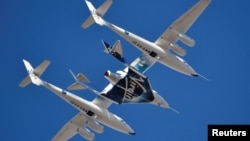 FILE - Virgin Galactic rocket plane, the WhiteKnightTwo carrier airplane, with SpaceShipTwo passenger craft takes off from Mojave Air and Space Port in Mojave, Calif., Feb. 22, 2019. 