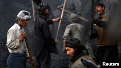 Afghan workers shovel coal outside Kabul, earning an average of $10 a day, Jan. 19, 2015.