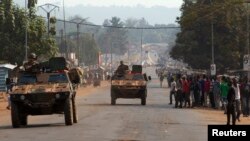 French peacekeeping soldiers advance in armored vehicles in Miskine district, a neighborhood that in the past few days experienced violent sectarian clashes, in the capital Bangui, Central African Republic, Jan. 30, 2014. 