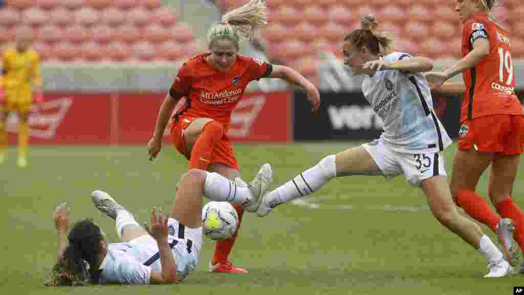 Houston Dash midfielder Bri Visalli, center, battles with Portland Thorns' Rocky Rodriguez, left, and Gabby Seiler (35) during the second half of an NWSL Challenge Cup soccer semifinal match Wednesday, July 22, 2020, in Sandy, Utah. (AP Photo/Rick Bowmer)
