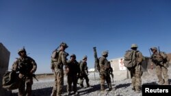 FILE - US troops wait for their helicopter flight at an Afghan National Army (ANA) Base in Logar province, Afghanistan.
