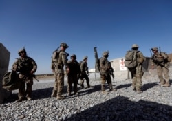 FILE - US troops wait for their helicopter flight at an Afghan National Army (ANA) Base in Logar province, Afghanistan.
