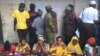 Tanzanians wait before the polls open for their turn to vote in the general election, Kinondoni, Dar es Salaam, Tanzania, Oct. 25, 2015.