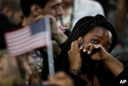 FILE - a woman weeps as election results are reported during Democratic presidential nominee Hillary Clinton's election night rally in the Jacob Javits Center glass enclosed lobby in New York.