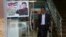 A Palestinian customer walks out of a shawarma restaurant with a poster of North Korean leader Jim Jong at the entrance of it in Jebaliya refugee camp, Gaza Strip, Dec. 14, 2017. 