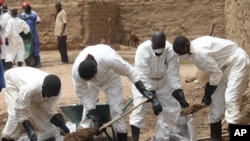 Local health workers remove earth contaminated by lead from a family compound in the village of Dareta in Gusau, Nigeria, Jun. 10, 2010.