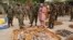 Nigerian military officials stand near ammunition seized from suspected members of Hezbollah after a building raid, Kano, May 30, 2013.