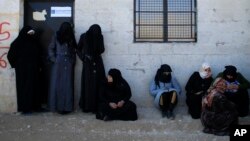 Women standing outside the Free Legal Support Program office in the shelter in Jibreen, Syria, Jan. 21, 2017. 