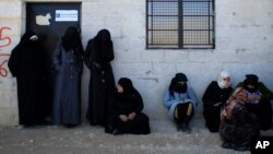 Women standing outside the Free Legal Support Program office in the shelter in Jibreen, Syria, Jan. 21, 2017. 