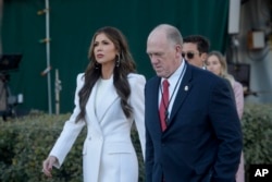 Homeland Security Secretary Kristi Noem and White House border czar Tom Homan walk at the White House in Washington, Jan. 29, 2025.