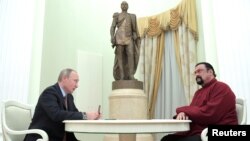 俄罗斯总统普京在莫斯科克里姆林宫授予美国好莱坞动作明星史蒂文·西格尔一本俄罗斯护照。 （2016年11月25日）