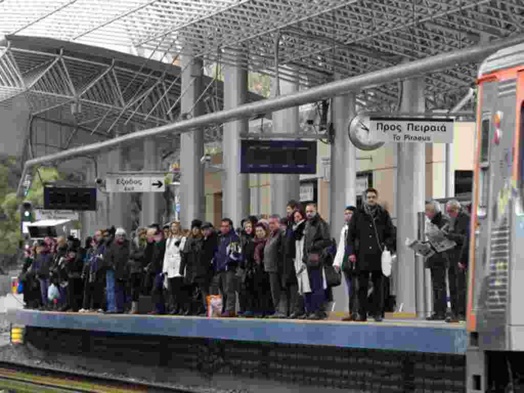 Commuters wait for the first train after a five-hour work stoppage by urban rail workers, as all other public transport employees are on a 48-hour strike, in Athens on February 10, 2012. (AP)