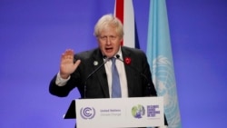 British Prime Minister Boris Johnson waves as he finishes his press conference at the COP26 U.N. Climate Summit, in Glasgow, Scotland, Nov. 10, 2021.