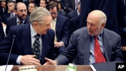 FILE - Soros Fund Management chairman George Soros, left, shakes hands with Renaissance Technologies President James Simons on Capitol Hill in Washington.