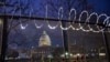 Flowers are placed along the razor wire fencing that now surrounds the U.S. Capitol on Jan. 15, 2021, in Washington.