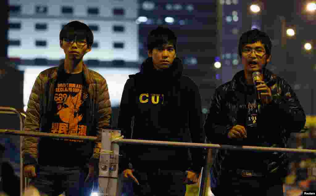 Student leaders Joshua Wong (left to right), Lester Shum and Alex Chow urge pro-democracy protesters to pack up their tents and leave the encampment at an Occupy Central rally outside the Legislative Council at Admiralty, in Hong Kong, Dec. 10, 2014.