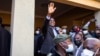 FILE - Then-President-elect Hakainde Hichilema (C) waves to supporters after a press briefing at his residence in Lusaka, Zambia, Aug. 16, 2021.