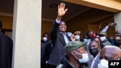 FILE - Then-President-elect Hakainde Hichilema (C) waves to supporters after a press briefing at his residence in Lusaka, Zambia, Aug. 16, 2021.
