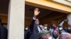 President-elect Hakainde Hichilema (C) waves to supporters after a press briefing at his residence in Lusaka, Zambia, Aug. 16, 2021.
