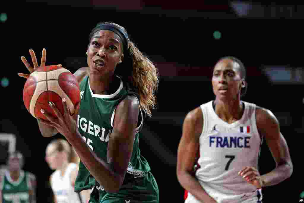 Nigeria&#39;s Victoria Macaulay, drives past France&#39;s Sandrine Gruda (7) during a women&#39;s basketball preliminary round game at the 2020 Summer Olympics, Friday, July 30, 2021, in Saitama, Japan. (AP Photo/Charlie Neibergall)