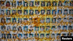 Portraits of students who died in the mid-April Sewol ferry disaster, decorated by yellow ribbons dedicated to the victims, are pictured in central Seoul, October 27, 2014.