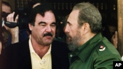 FILE - Director Oliver Stone and Cuban leader Fidel Castro, Feb. 21, 2002, after wrapping up shooting of a documentary in Ernest Hemingway's preferred bar "La Terraza" in Cojimar near Havana, Cuba.
