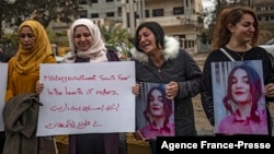 Syrian Kurds demonstrate outside a UN building, calling on authorities to help release young girls they say were abducted and recruited into fighting, in the northeast city of Qamishli on Nov. 28, 2021. 