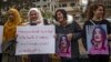 Syrian Kurds demonstrate outside a UN building, calling on authorities to help release young girls they say were abducted and recruited into fighting, in the northeast city of Qamishli on Nov. 28, 2021. 