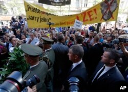 Czech Prime Minister Andrej Babis, front center, arrives to lay a wreath to honor the victims of the Soviet invasion of Czechoslovakia in 1968 at a ceremony in Prague, Czech Republic, Aug. 21, 2018.