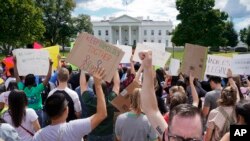 FILE - Supporters of the Deferred Action for Childhood Arrivals program demonstrate on Pennsylvania Avenue in front of the White House in Washington, Sept. 9, 2017. 