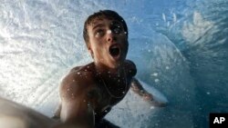 In this undated image taken from video, Tahitian-born surfer Kauli Vaast records himself surfing on the world-famous Teahupo’o wave in Tahiti. The Olympic surfing competition will be held next July at Teahupo’o as part of the 2024 Summer Games in Paris. (Kauli Vaast via AP)