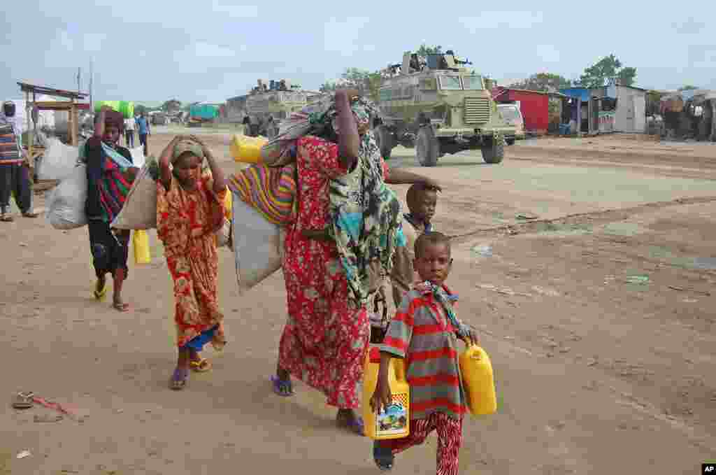 A newly displaced Somali family from the Bakool region walks through the streets of the capital Mogadishu, August 3, 2011. (Reuters)