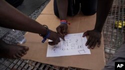 Rescued migrants draw a map of the Zawiya, Libya detention center run by the al-Nasr Martyrs militia, Sept. 23, 2019.