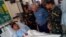 Philippines Defense Secretary Voltaire Gazmin (2nd R) and military chief General Hernando Iriberri (R) visit one of the 53 wounded soldiers at a military hospital in Zamboanga on the southern Philippine island of Mindanao on April 10, 2016, a day after soldiers clashed with the extremist Abu Sayyaf group. 