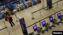 FILE - Passengers check in at a Latam Airlines counter in Santos Dumont Airport during the coronavirus pandemic, in Rio de Janeiro, Brazil, May 20, 2020.