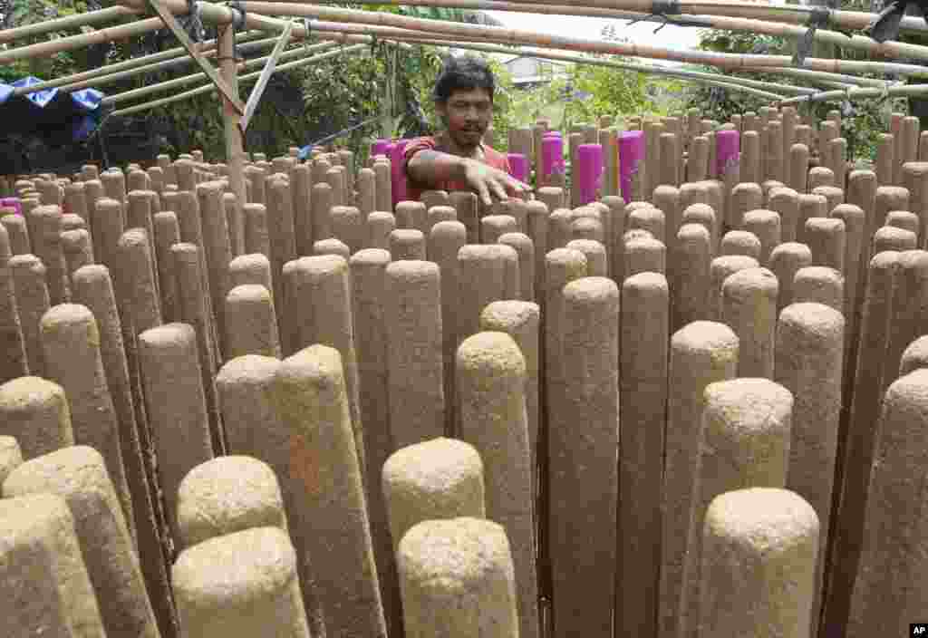 A worker arranges large incense sticks to be sold for the preparation of the Lunar New Year in Tangerang, Indonesia, Jan. 10, 2017.