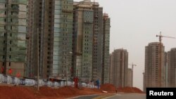 FILE - Residential homes line a deserted street in the Kangbashi district of the town of Ordos in China's Inner Mongolia Autonomous Region.