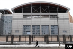 FILE - A man walks past the building of the headquarters of the Russian General Staff's Main Intelligence Department (GRU) in Moscow, Dec. 30, 2016.
