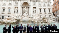G20 leaders toss a coin into Rome's iconic Trevi Fountain on the sidelines of the G-20 summit in Rome, Oct. 31, 2021.