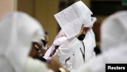 A judge counts votes at a polling station in Kuwait City July 27, 2013.