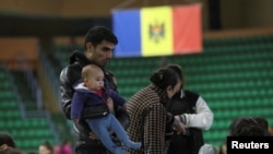 FILE PHOTO: People fleeing Russia's invasion of Ukraine rest in a temporary refugee centre in Chisinau