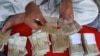 A Pakistani money changer counts Pak rupees in Karachi, Pakistan on Oct 24, 2008.