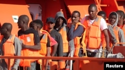 FILE - Migrants are seen on a rescue boat at the port of Malaga, southern Spain, Sept. 23, 2018. 