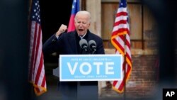 President-elect Joe Biden speaks at a drive-in rally for Georgia Democratic candidates for U.S. Senate Raphael Warnock and Jon Ossoff, in Atlanta, Dec. 15, 2020.