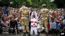 FILE - Ethiopian soldiers try to stop protesters in Bishoftu, in the Oromia region of Ethiopia. 