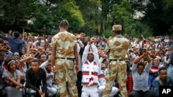 FILE - Ethiopian soldiers try to stop protesters in Bishoftu, in the Oromia region of Ethiopia. 