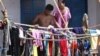 A Cambodian couple dry clothes at their home in flood. 