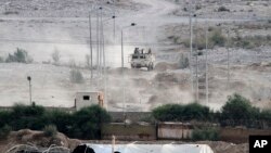 Egyptian soldiers sit atop a military personnel carrier securing the Egyptian side of the border between Egypt and Rafah in the southern Gaza Strip, July 1, 2015. 