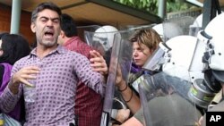 Riot police clash with protesters at the gate of the ancient Acropolis site, Athens' most popular tourist site, which was blocked by angry workers, 14 Oct 2010